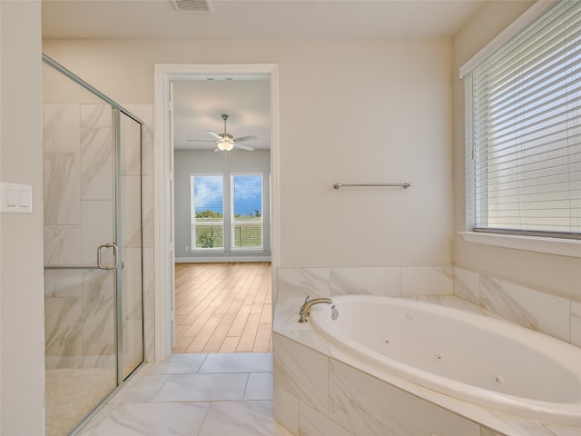 bathroom featuring a tub with jets, ceiling fan, visible vents, and a stall shower
