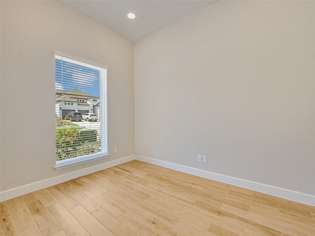 unfurnished room featuring baseboards, recessed lighting, and wood finished floors