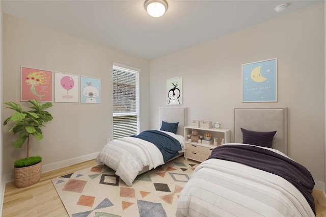131 Plumbago Loop, Bastrop, TX 78602 - bedroom with baseboards and light wood-style floors