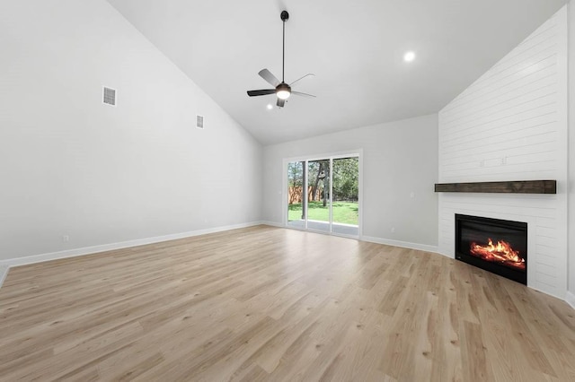 unfurnished living room featuring a ceiling fan, light wood-style flooring, visible vents, high vaulted ceiling, and a fireplace