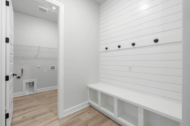 mudroom featuring baseboards, light wood-style floors, and visible vents