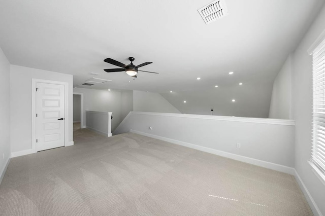 bonus room featuring light colored carpet, visible vents, baseboards, and a ceiling fan