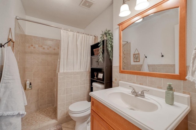 full bath with a tile shower, visible vents, tile walls, and toilet
