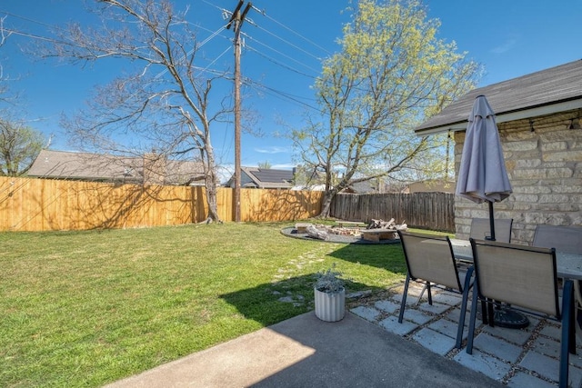 view of yard with outdoor dining space, a patio, and a fenced backyard