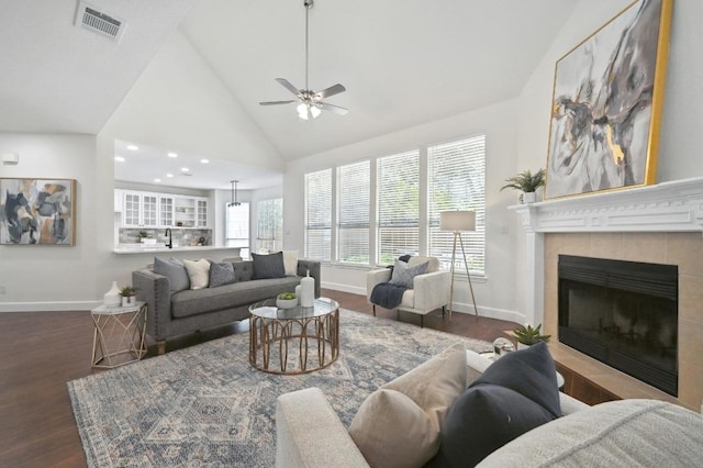 7802 Cheno Cortina Trl, Austin, TX 78749 - living area with a ceiling fan, wood finished floors, a tiled fireplace, baseboards, and visible vents