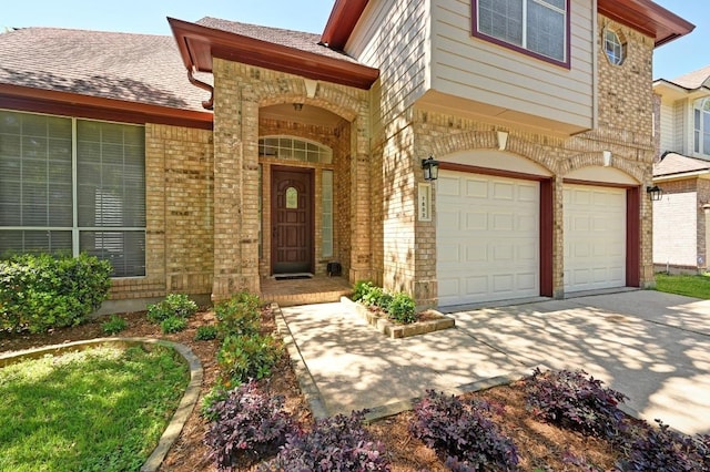 7802 Cheno Cortina Trl, Austin, TX 78749 - doorway to property with an attached garage, brick siding, and concrete driveway