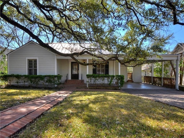 1621 Watchhill Rd, Austin, TX 78703 - ranch-style home featuring covered porch, a front lawn, a carport, and driveway