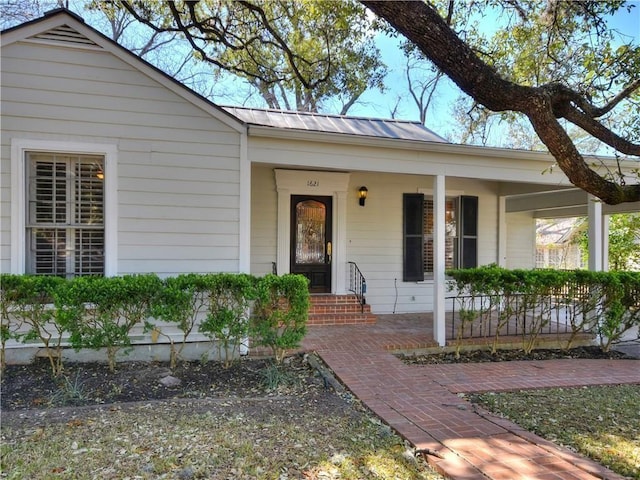 view of front of house featuring a porch and metal roof