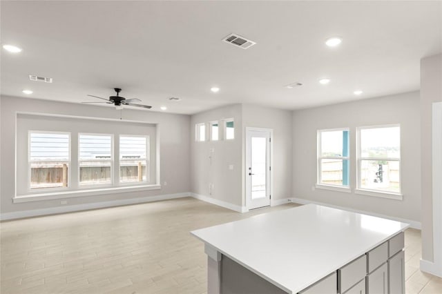 9708 Petrichor Blvd, Manor, TX 78653 - kitchen featuring baseboards, recessed lighting, open floor plan, light countertops, and a ceiling fan