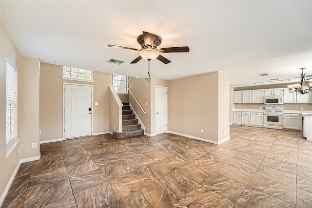2813 Single Trace Ct, Austin, TX 78728 - unfurnished living room featuring stairs, visible vents, ceiling fan with notable chandelier, and baseboards