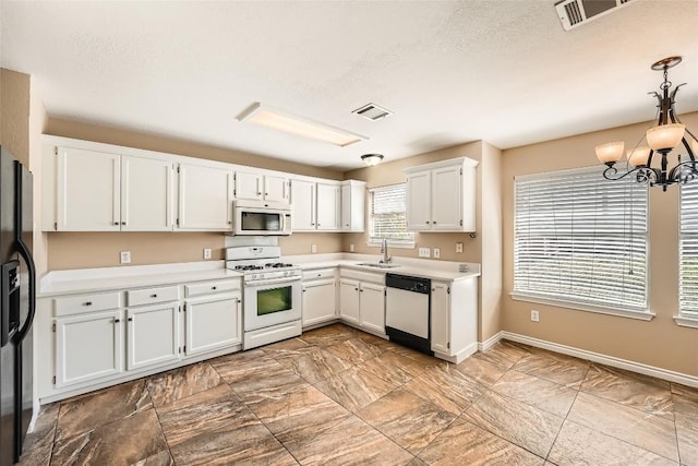 2813 Single Trace Ct, Austin, TX 78728 - kitchen with a sink, visible vents, light countertops, and white appliances