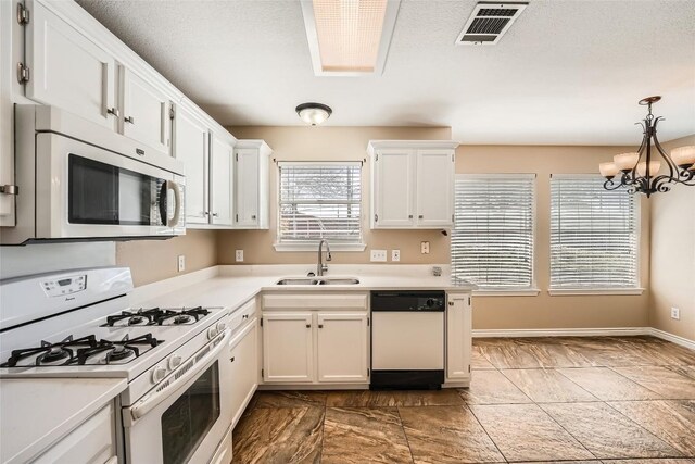 2813 Single Trace Ct, Austin, TX 78728 - kitchen featuring white appliances, light countertops, white cabinets, visible vents, and a sink