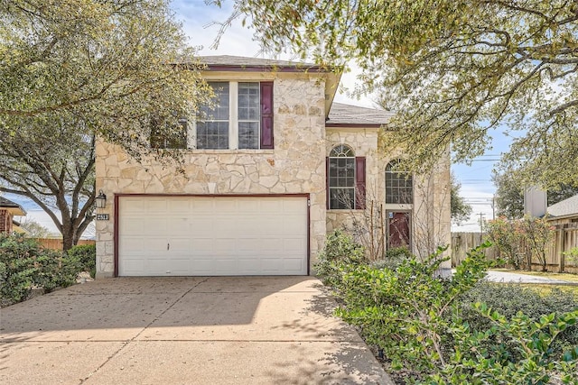 2813 Single Trace Ct, Austin, TX 78728 - view of front facade with driveway, fence, stone siding, and a garage