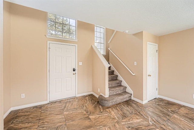 2813 Single Trace Ct, Austin, TX 78728 - entrance foyer with baseboards, a textured ceiling, marble finish floor, and stairs
