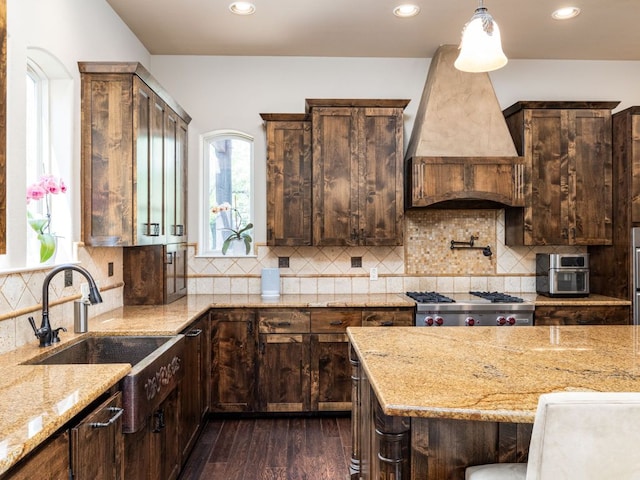 3701 Pappys Way, Austin, TX 78730 - kitchen featuring dark wood-style flooring, light stone countertops, custom exhaust hood, recessed lighting, and dark brown cabinetry