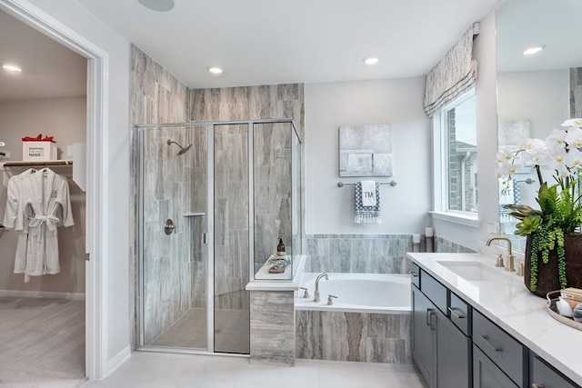 9709 Boathouse Dr, Austin, TX 78744 - full bathroom with vanity, a bath, a stall shower, tile patterned floors, and recessed lighting