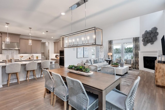 9709 Boathouse Dr, Austin, TX 78744 - dining area with light wood finished floors, recessed lighting, and a fireplace