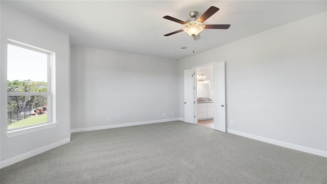 9709 Boathouse Dr, Austin, TX 78744 - empty room featuring light colored carpet, a ceiling fan, and baseboards