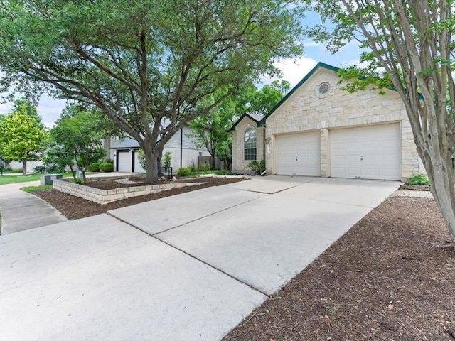 906 Woodhollow Ln, Cedar Park, TX 78613 - view of front of home with concrete driveway, an attached garage, and stone siding