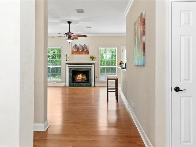 906 Woodhollow Ln, Cedar Park, TX 78613 - hallway featuring visible vents, ornamental molding, wood finished floors, and a healthy amount of sunlight