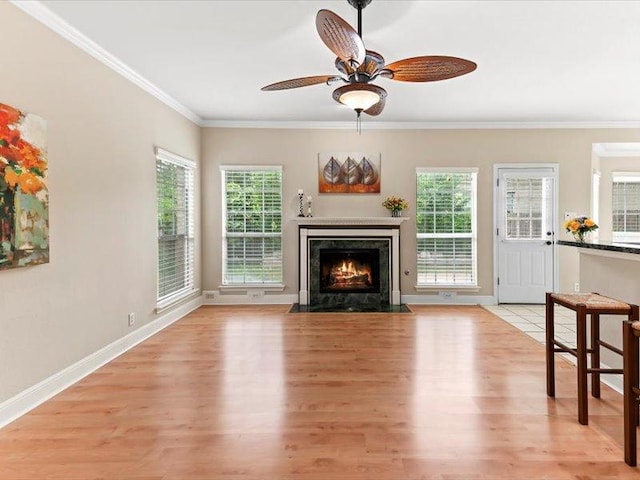 906 Woodhollow Ln, Cedar Park, TX 78613 - living area featuring a ceiling fan, baseboards, light wood finished floors, ornamental molding, and a premium fireplace