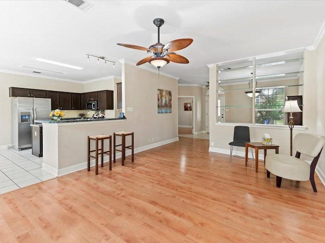 906 Woodhollow Ln, Cedar Park, TX 78613 - living area with ornamental molding, a ceiling fan, light wood finished floors, and visible vents
