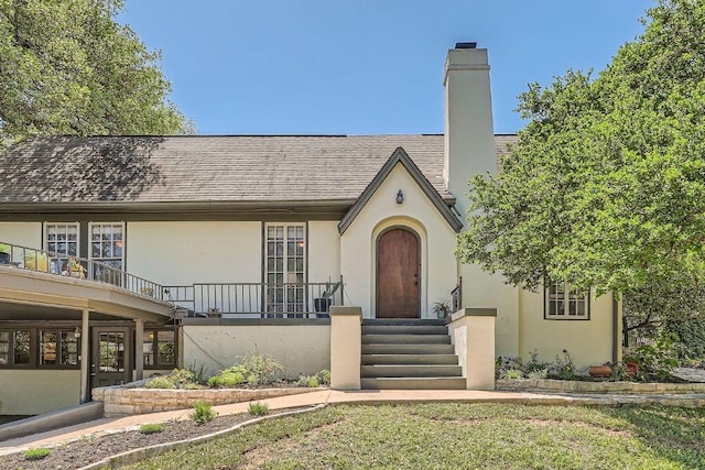 809 Edgecliff Ter, Austin, TX 78704 - tudor-style house with stucco siding, a chimney, and a shingled roof