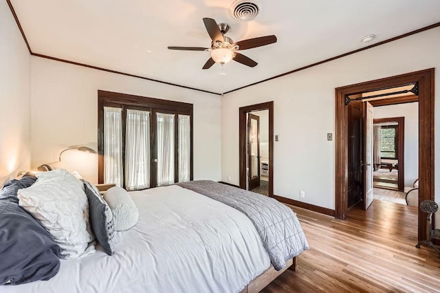 809 Edgecliff Ter, Austin, TX 78704 - bedroom featuring baseboards, wood finished floors, ornamental molding, and a ceiling fan
