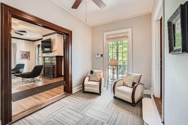 809 Edgecliff Ter, Austin, TX 78704 - sitting room featuring ceiling fan, a fireplace, ornamental molding, and baseboards
