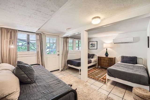 809 Edgecliff Ter, Austin, TX 78704 - bedroom featuring light tile patterned floors, a wall unit AC, a textured ceiling, and multiple windows
