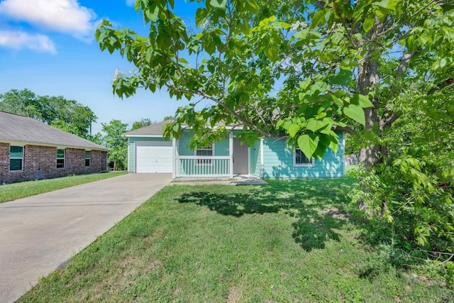 128 2nd Ave, Taylor, TX 76574 - view of front of house featuring concrete driveway, a front yard, and an attached garage