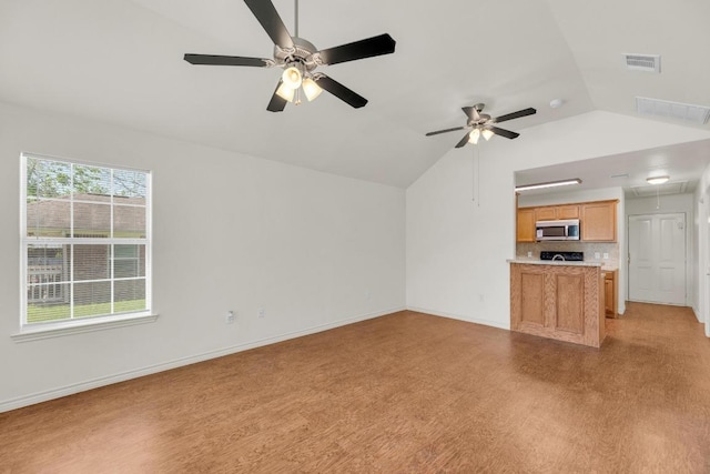128 2nd Ave, Taylor, TX 76574 - unfurnished living room featuring attic access, lofted ceiling, ceiling fan, and light wood-style floors