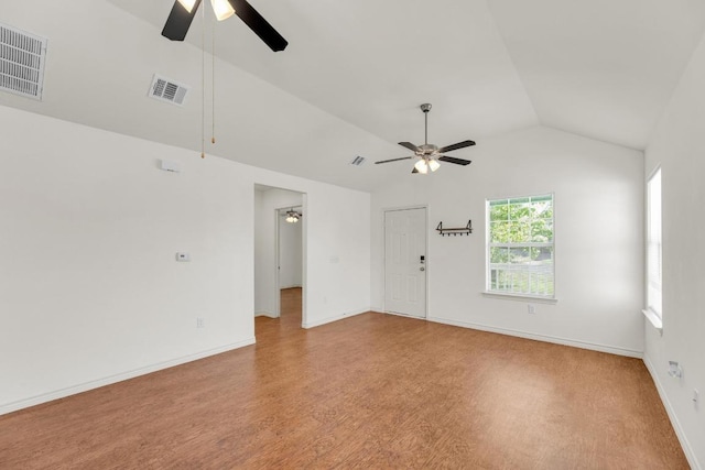 128 2nd Ave, Taylor, TX 76574 - unfurnished living room featuring ceiling fan, lofted ceiling, and light wood-style floors