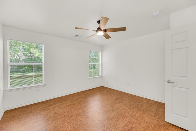 128 2nd Ave, Taylor, TX 76574 - unfurnished room with plenty of natural light, light wood-style flooring, ceiling fan, and a smoke detector
