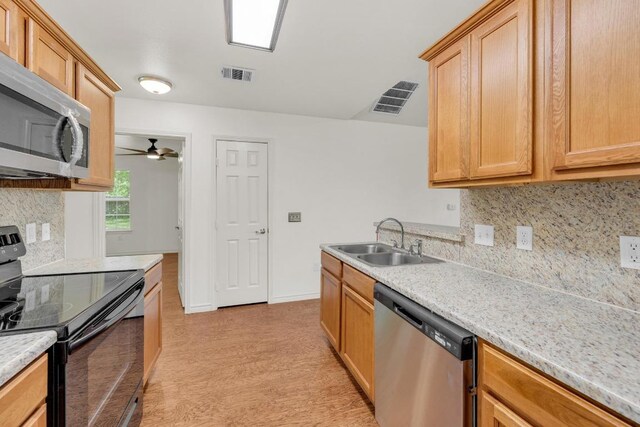 128 2nd Ave, Taylor, TX 76574 - kitchen with stainless steel appliances, backsplash, light countertops, and ceiling fan