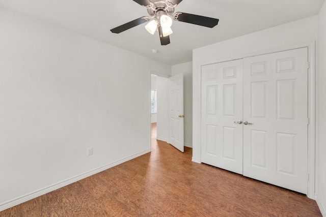 128 2nd Ave, Taylor, TX 76574 - unfurnished bedroom with wood finished floors, a closet, and a ceiling fan