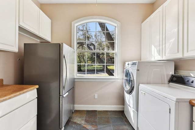 201 Mcconnell Dr, West Lake Hills, TX 78746 - laundry area featuring washer and dryer, cabinet space, and dark stone finish floors