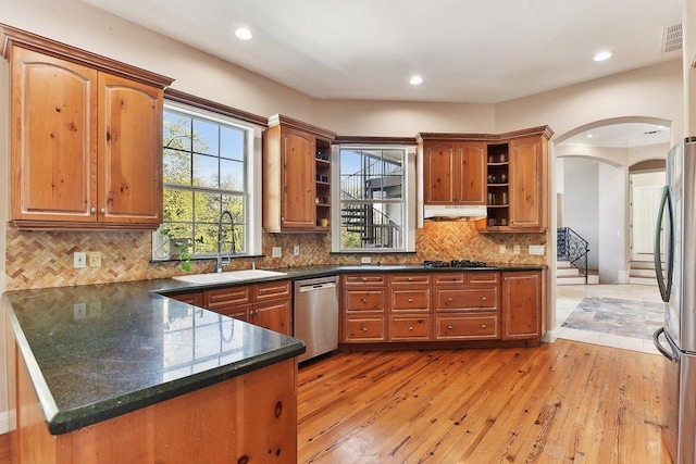 201 Mcconnell Dr, West Lake Hills, TX 78746 - kitchen featuring open shelves, stainless steel appliances, a peninsula, arched walkways, and recessed lighting
