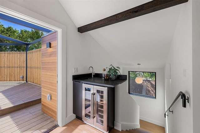2218 Haskell St, Austin, TX 78702 - indoor wet bar featuring beverage cooler, light wood finished floors, and baseboards