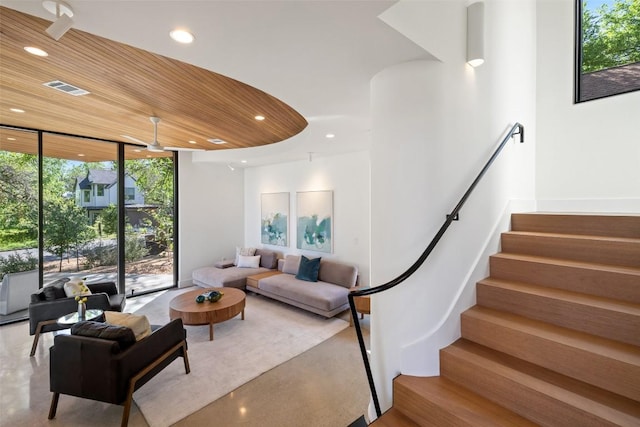 2218 Haskell St, Austin, TX 78702 - living room featuring floor to ceiling windows, recessed lighting, and stairs