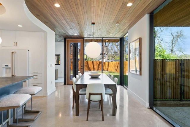 2218 Haskell St, Austin, TX 78702 - dining space featuring floor to ceiling windows, recessed lighting, wood ceiling, baseboards, and concrete floors