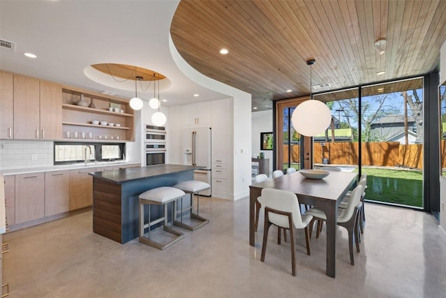 2218 Haskell St, Austin, TX 78702 - dining space featuring finished concrete floors, a wall of windows, recessed lighting, and wood ceiling