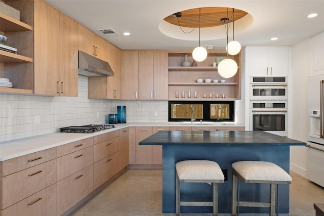 2218 Haskell St, Austin, TX 78702 - kitchen with open shelves, under cabinet range hood, white double oven, a breakfast bar, and light brown cabinetry