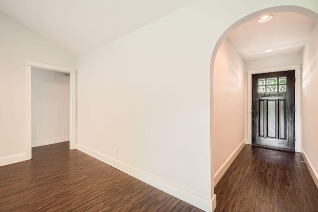 2700 Coatbridge Dr, Austin, TX 78745 - foyer featuring arched walkways, baseboards, dark wood-style floors, and vaulted ceiling
