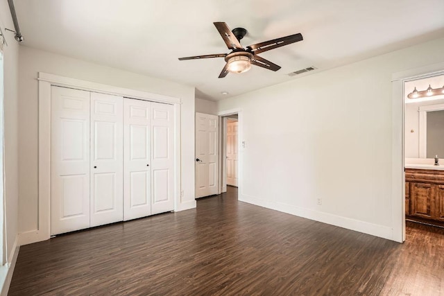 2700 Coatbridge Dr, Austin, TX 78745 - unfurnished bedroom with a closet, baseboards, dark wood finished floors, and visible vents