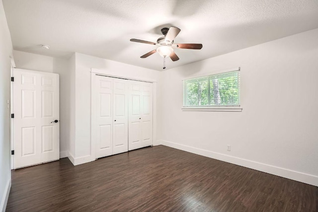 2700 Coatbridge Dr, Austin, TX 78745 - unfurnished bedroom featuring a closet, baseboards, a textured ceiling, and dark wood finished floors