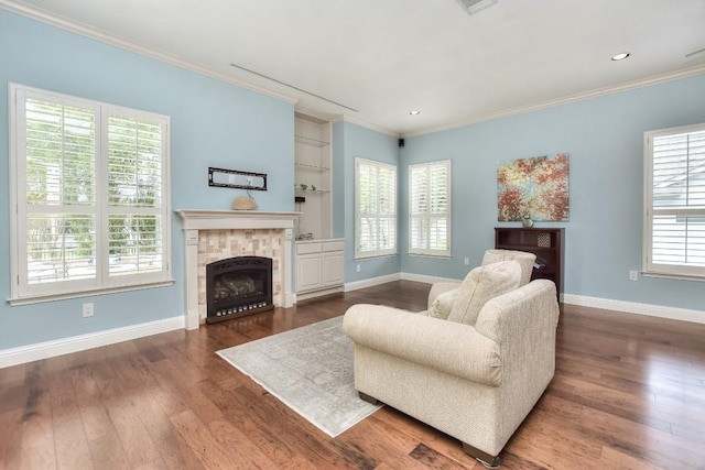 204 Whippoorwill Cv, Georgetown, TX 78633 - living area with ornamental molding, baseboards, dark wood finished floors, a fireplace, and built in features