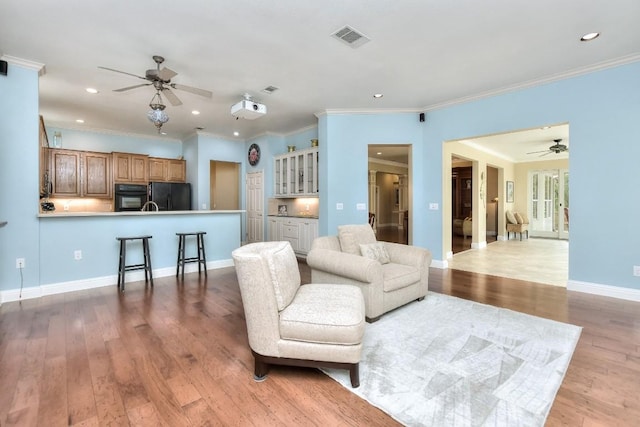 204 Whippoorwill Cv, Georgetown, TX 78633 - living area featuring ceiling fan, light wood finished floors, recessed lighting, crown molding, and baseboards