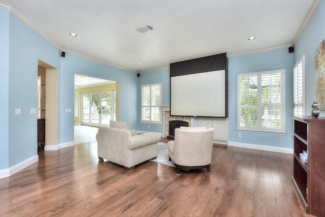 204 Whippoorwill Cv, Georgetown, TX 78633 - home theater featuring hardwood / wood-style floors, a fireplace, baseboards, ornamental molding, and recessed lighting
