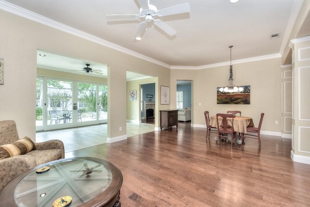 204 Whippoorwill Cv, Georgetown, TX 78633 - living room featuring healthy amount of natural light, wood finished floors, ornamental molding, baseboards, and recessed lighting